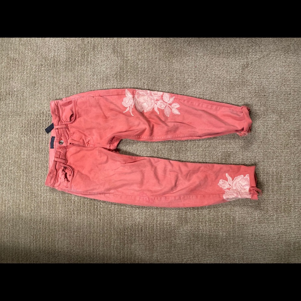 Men’s salmon colored rose jeans